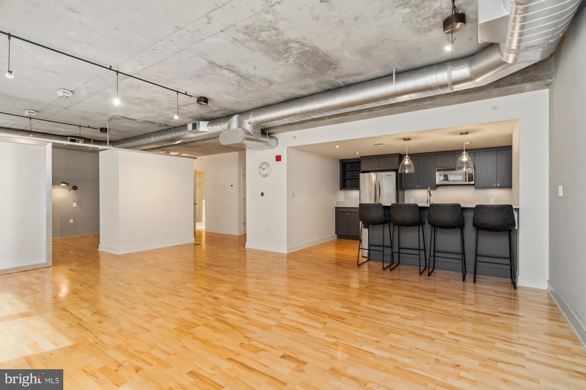 a view of a room with wooden floor and furniture