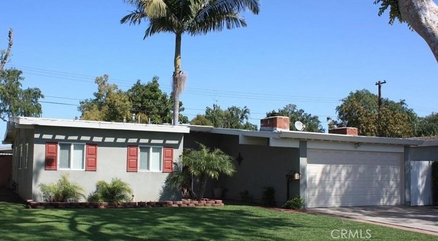 a view of a house with pool and a yard