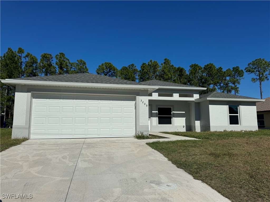 a front view of a house with a yard and garage