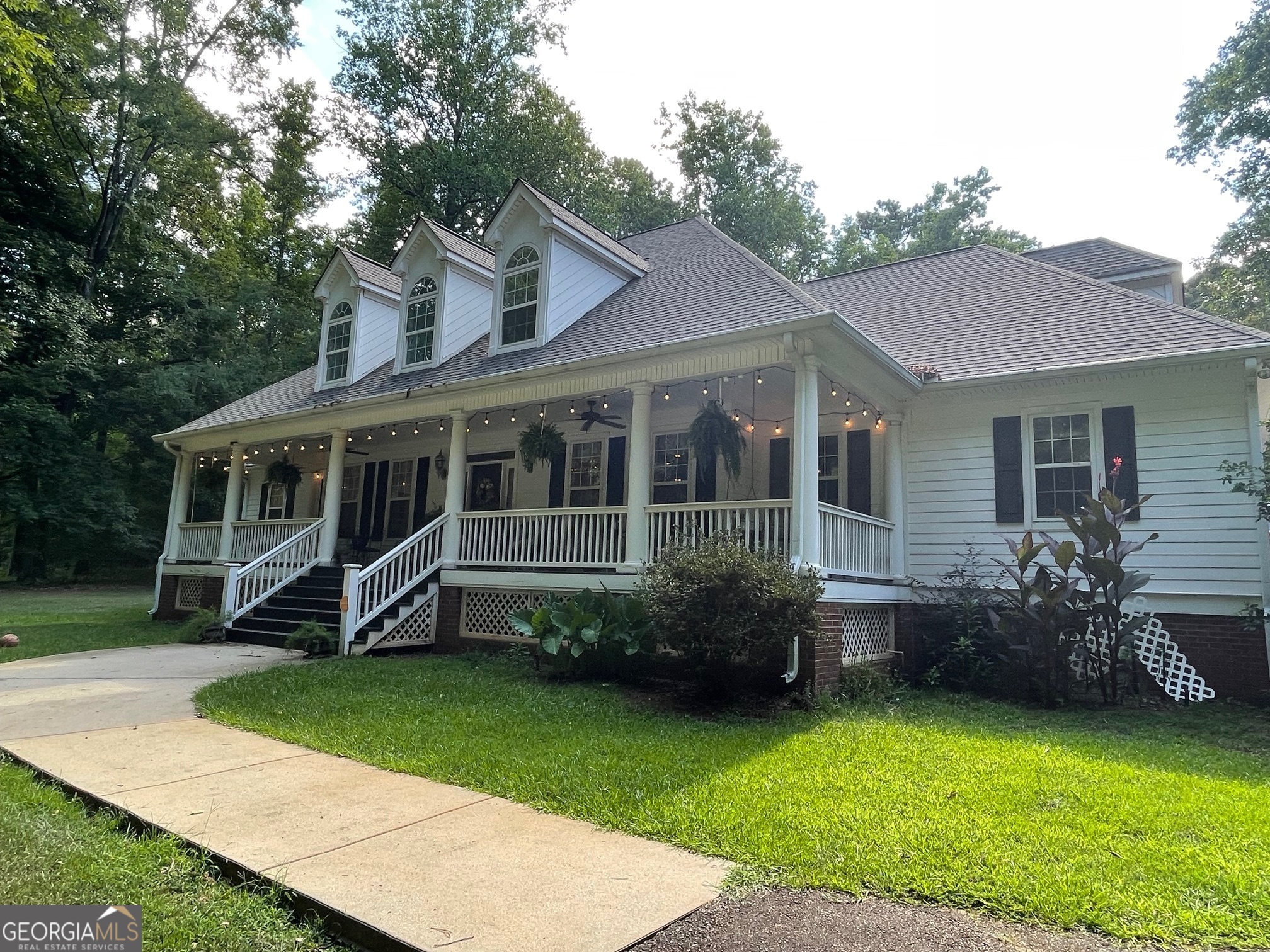 a view of a house with a yard and a patio