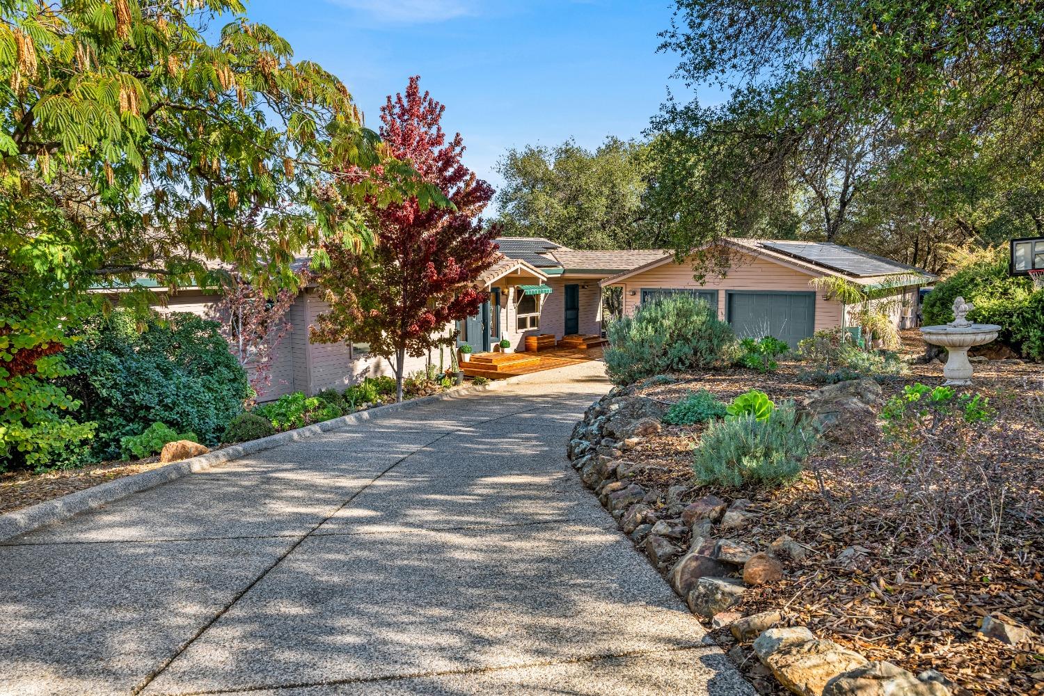 a front view of a house with a garden