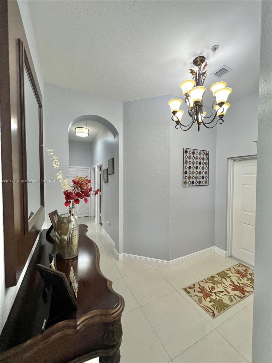 a living room with a chandelier furniture and a chandelier