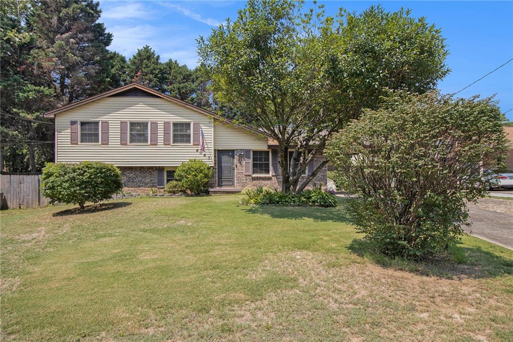 a front view of a house with a garden