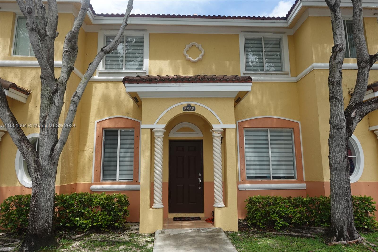 a front view of a house with garden