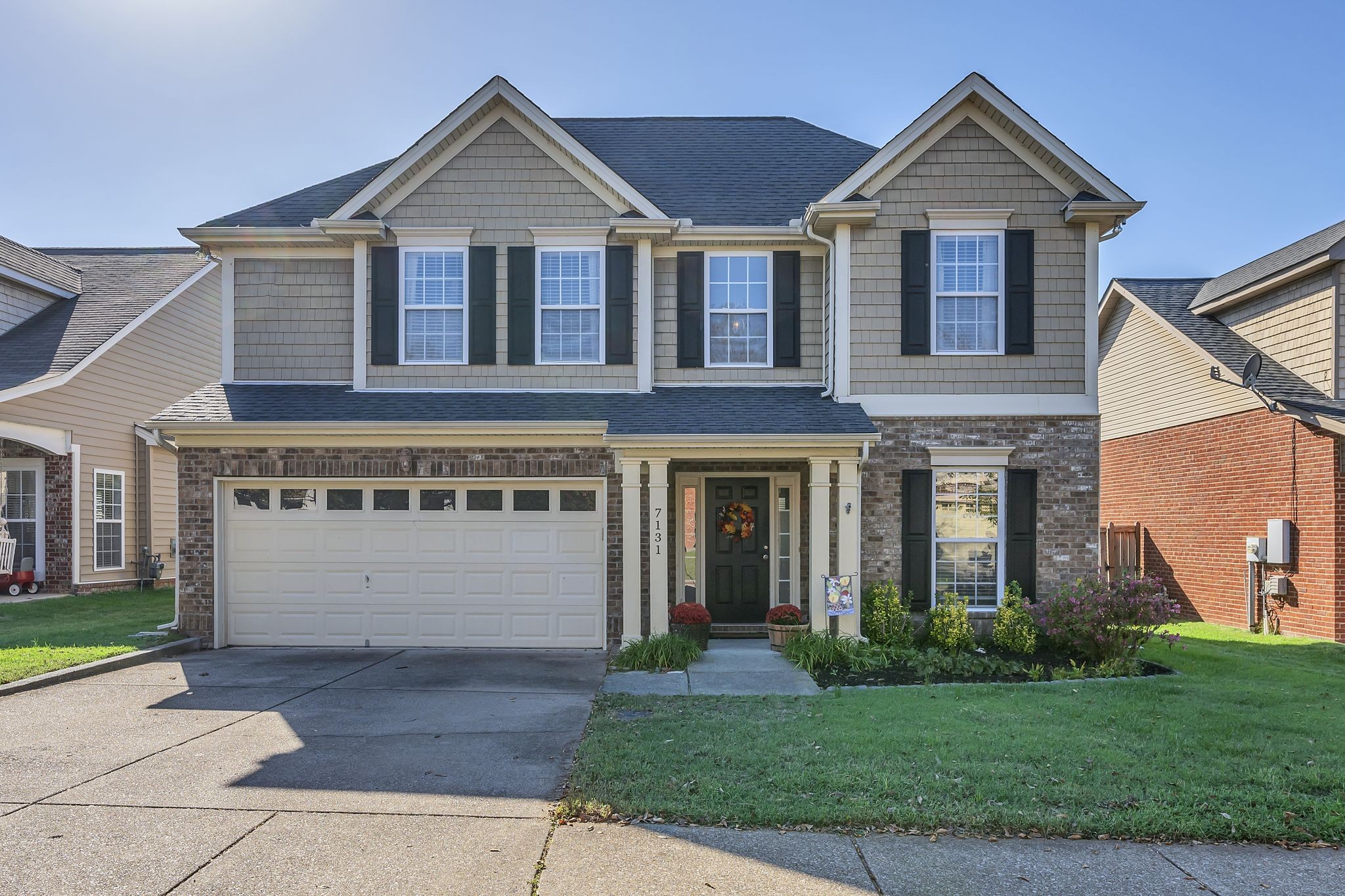 a front view of a house with a yard and garage