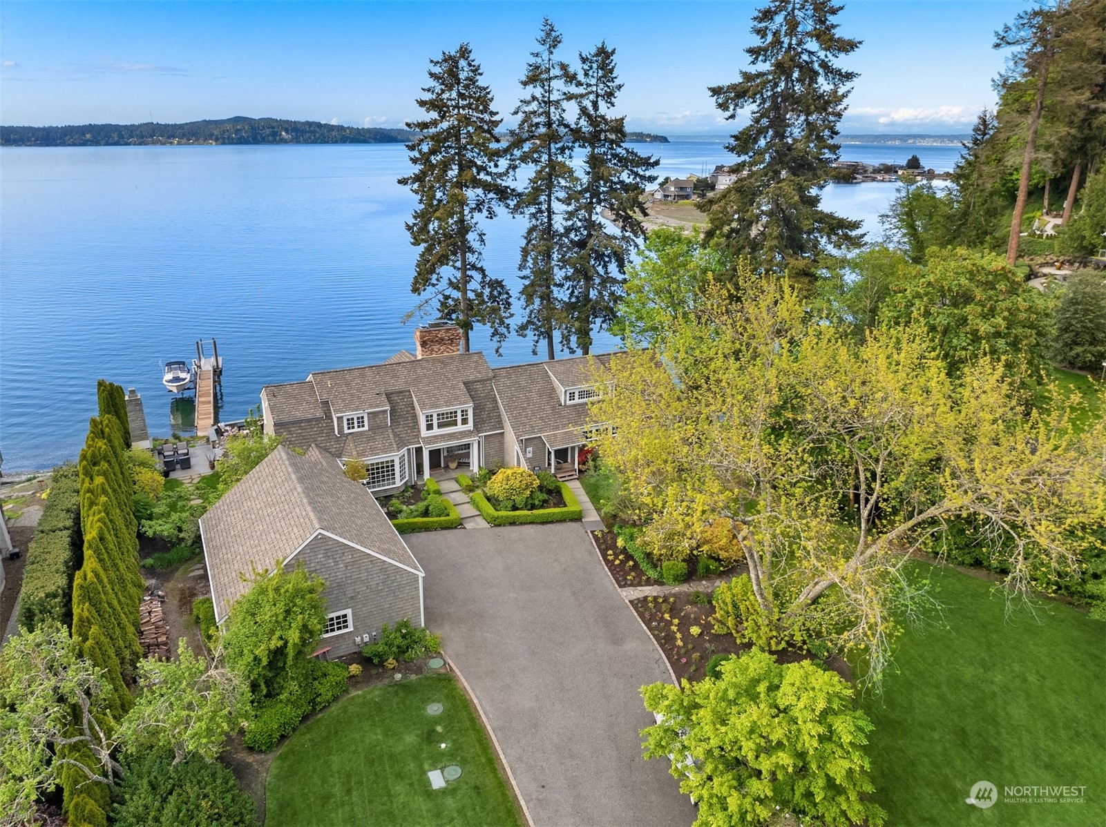 an aerial view of a house with a yard and large trees