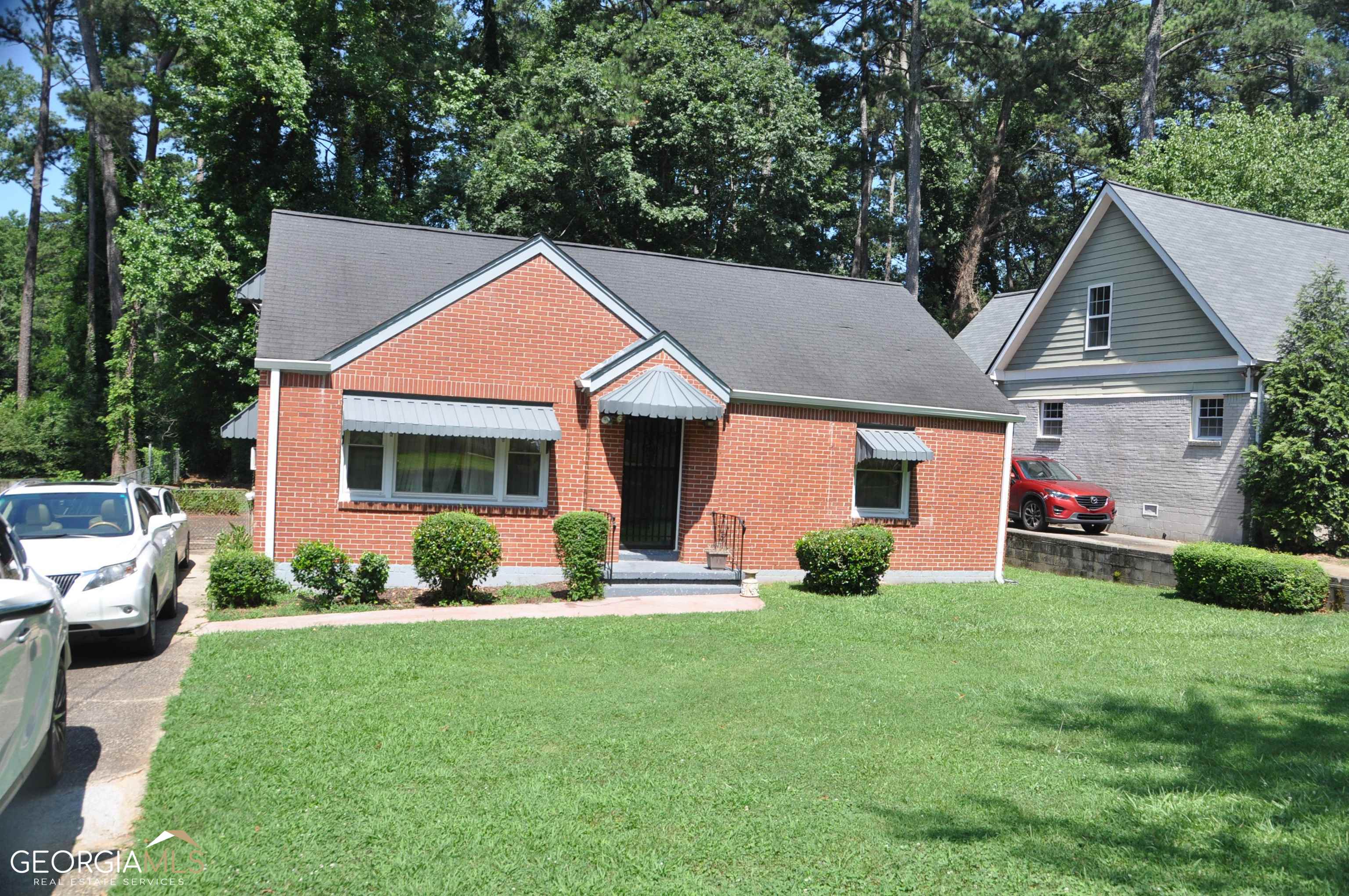 a front view of house with yard and green space