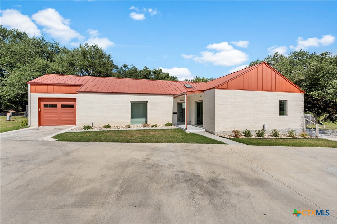 a view of a house with a backyard and a garage