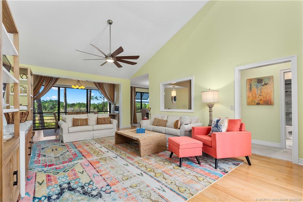 a living room with furniture a large window and a rug