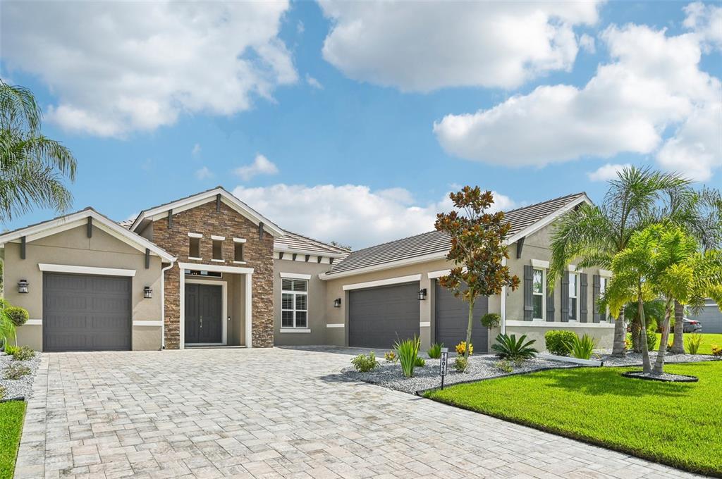 a front view of a house with a yard and garage