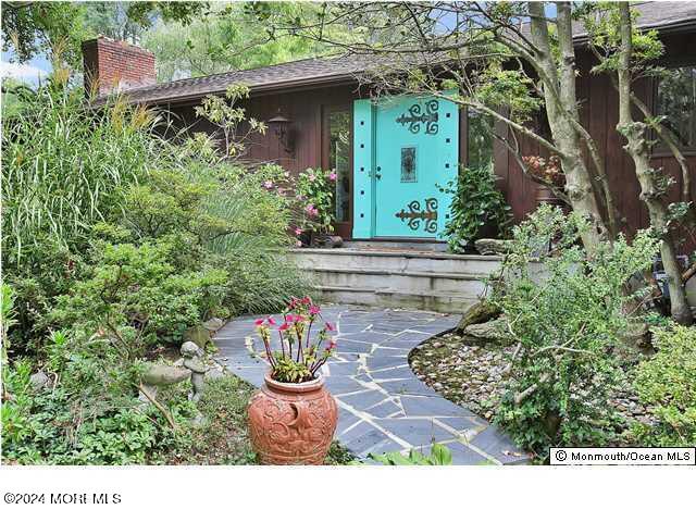 a view of a house with potted plants