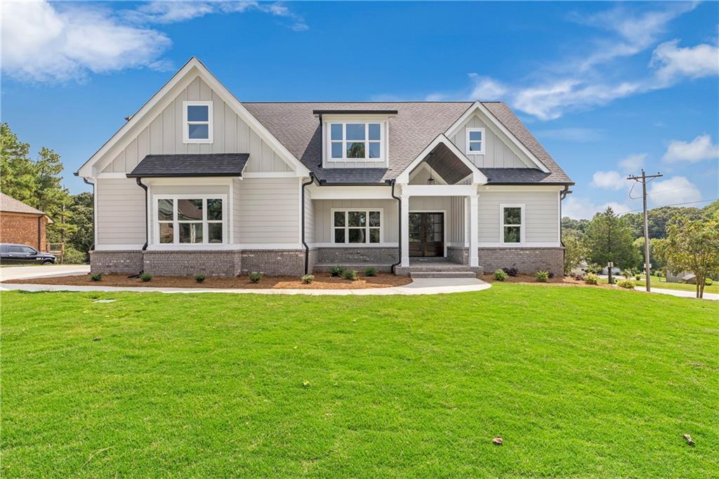 a front view of house with yard and green space