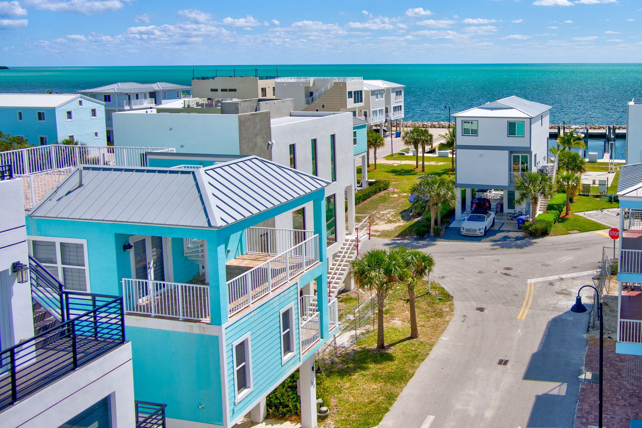 an aerial view of multiple houses with a yard