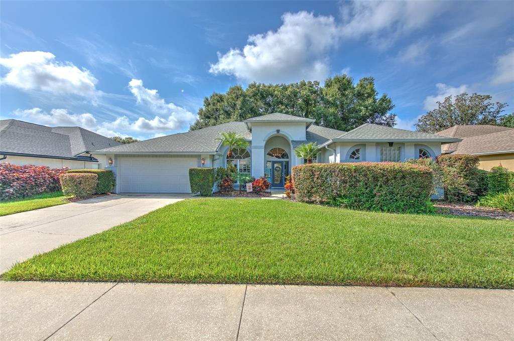 a front view of a house with a yard and garage