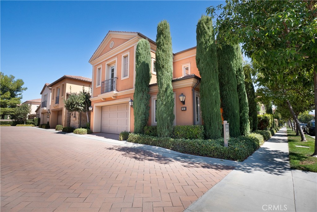 a front view of a house with a yard and trees