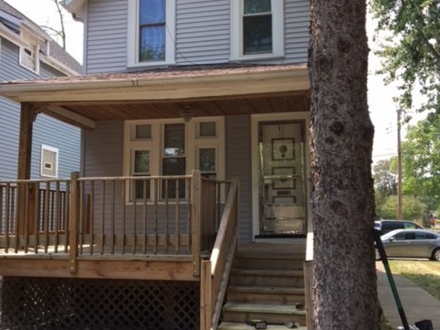 a view of a house with a small deck