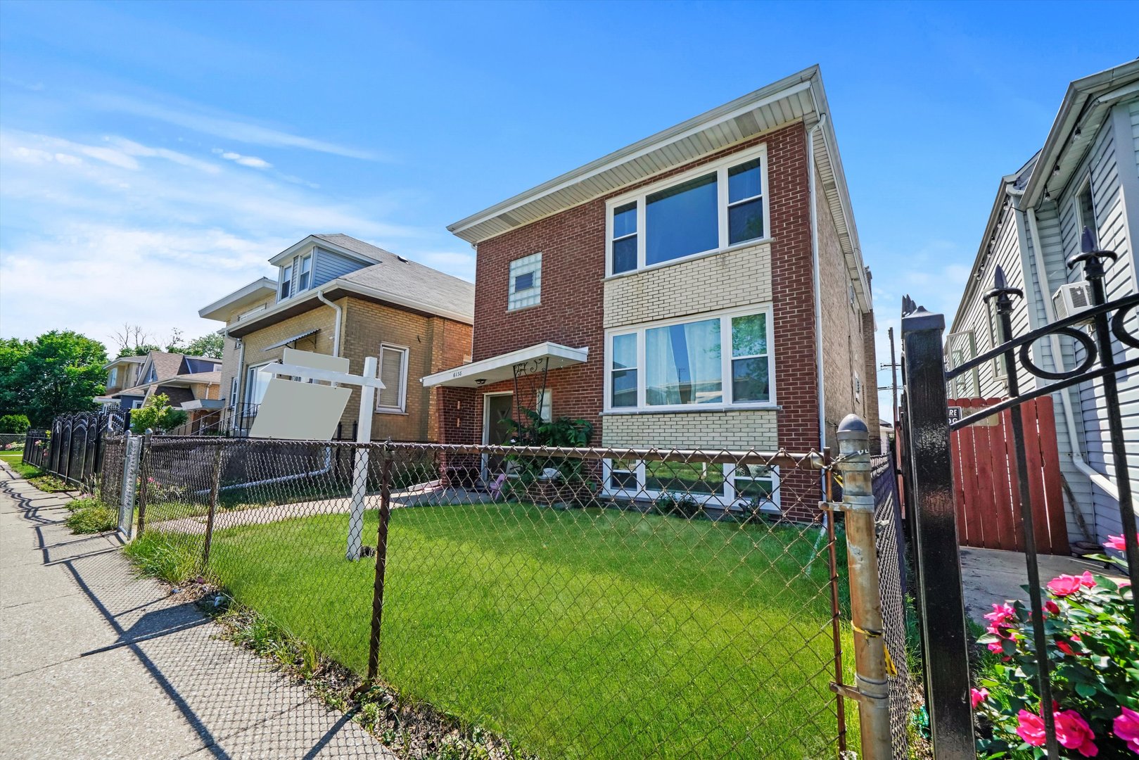 a view of a house with a yard and tree s