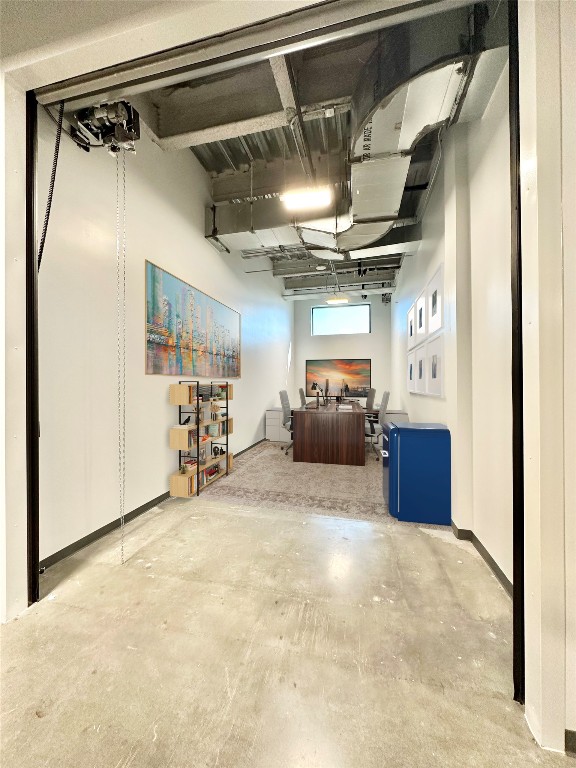 a view of a hallway with a chair and storage