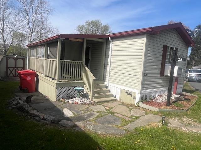 a view of a small house with backyard and sitting area