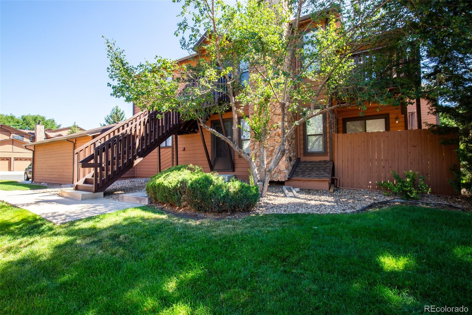 a view of a house with a yard and tree s