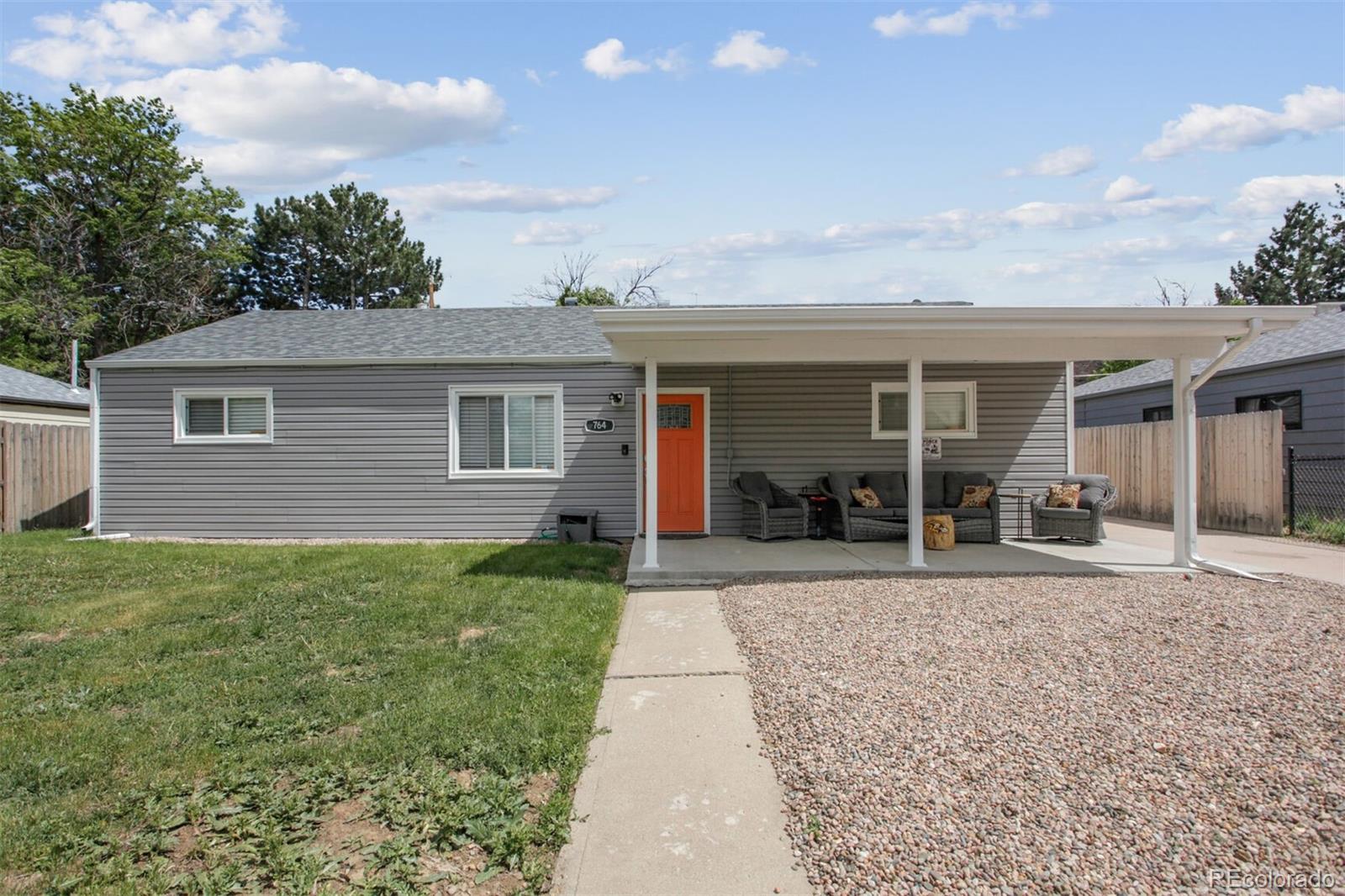 a front view of house with yard and green space