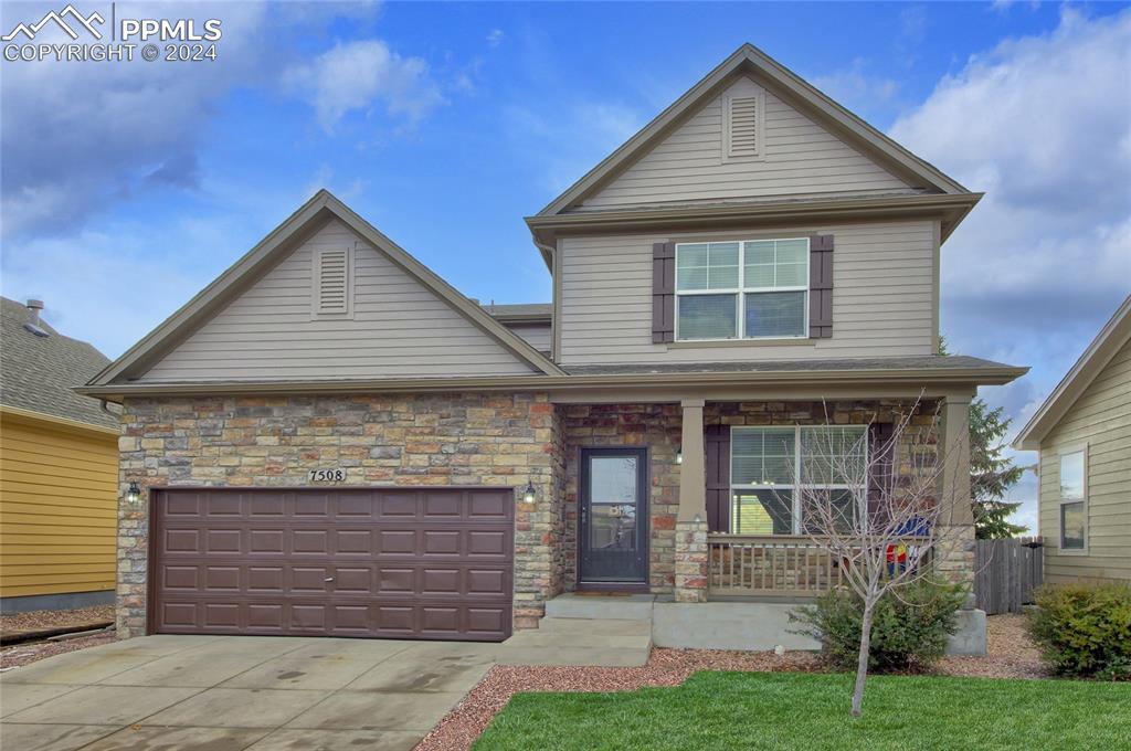 a front view of a house with a yard and garage