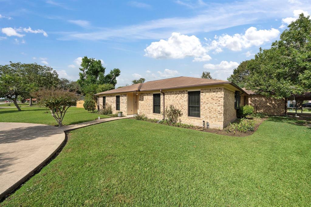 a view of a house with a yard and tree s