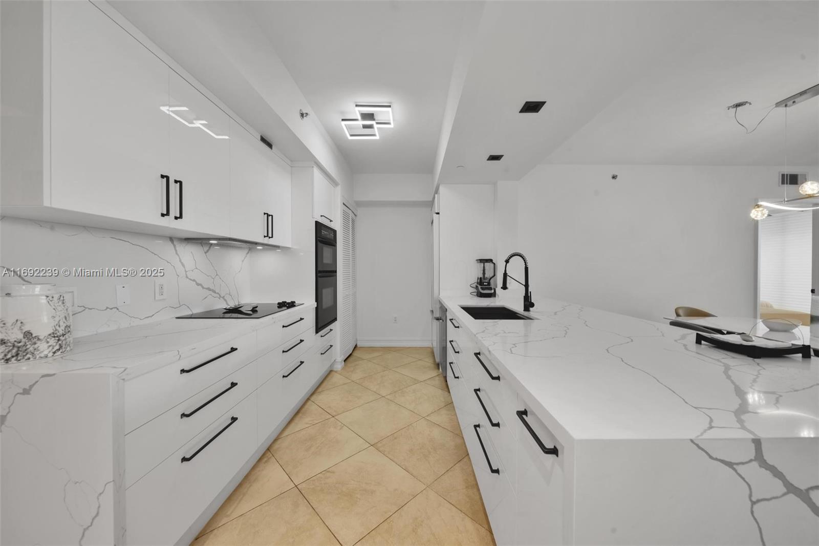 a kitchen with kitchen island a stove a sink and a refrigerator