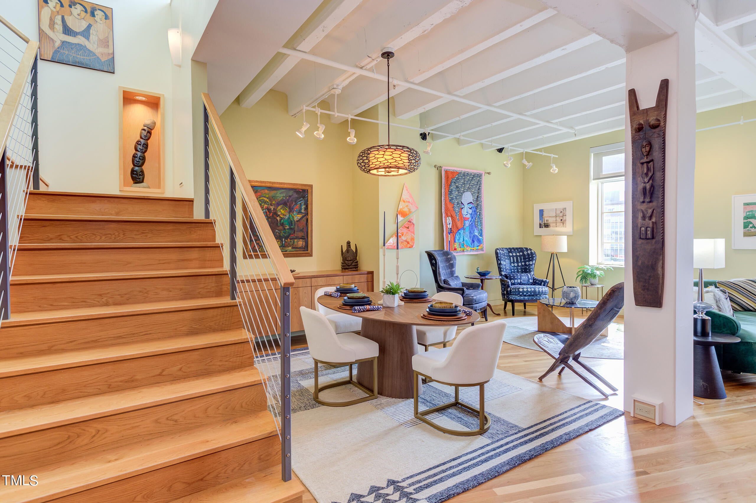 a room with lots of furniture and a chandelier