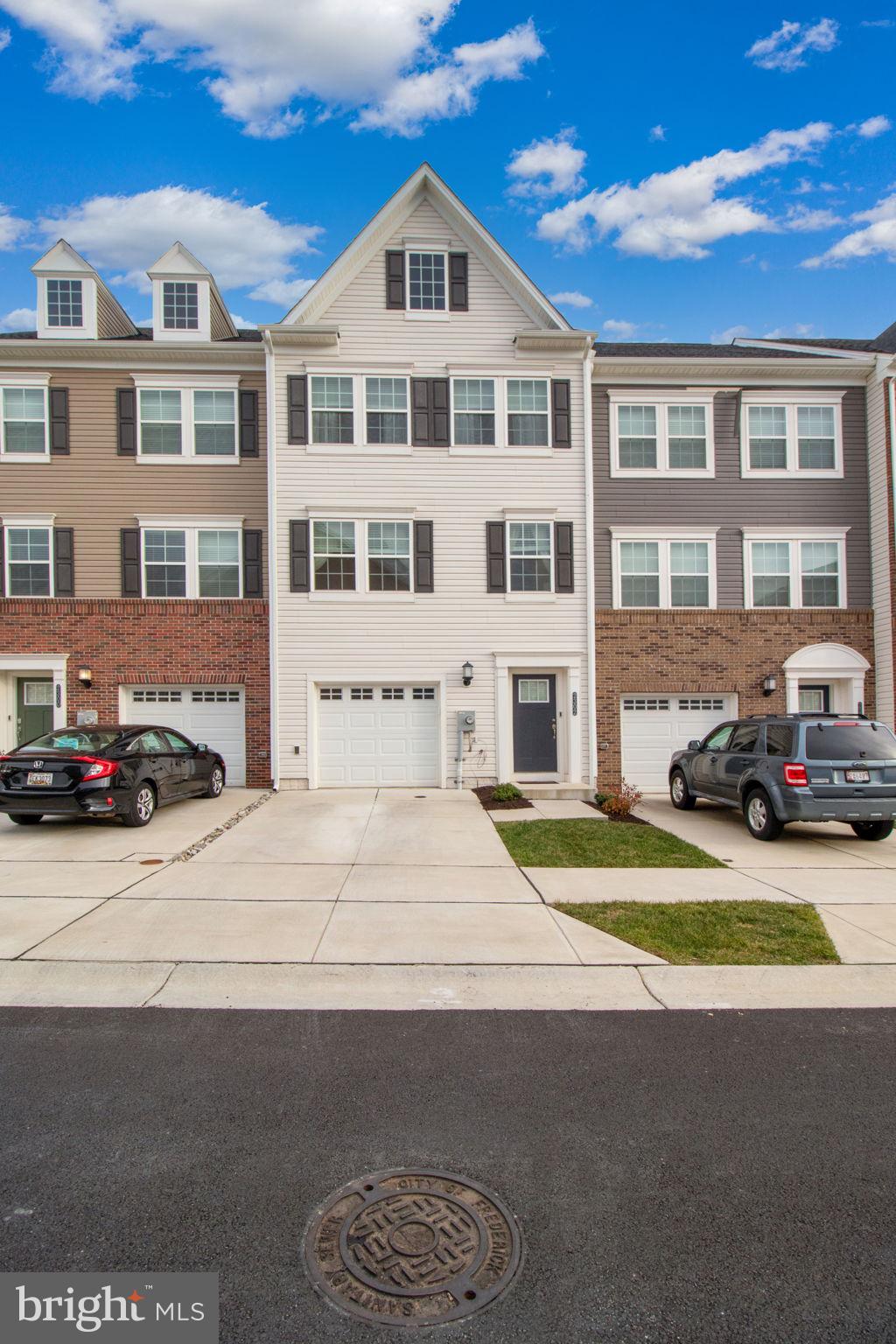 a front view of a residential apartment building with a yard