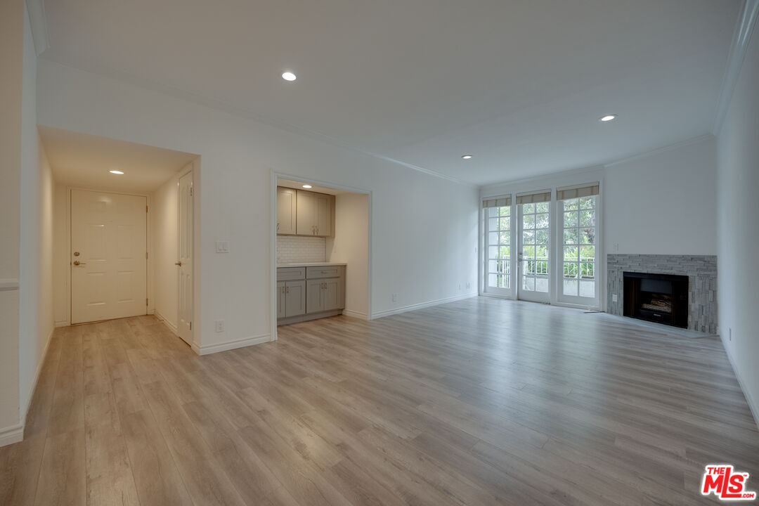 a view of a room wooden floor and a fireplace