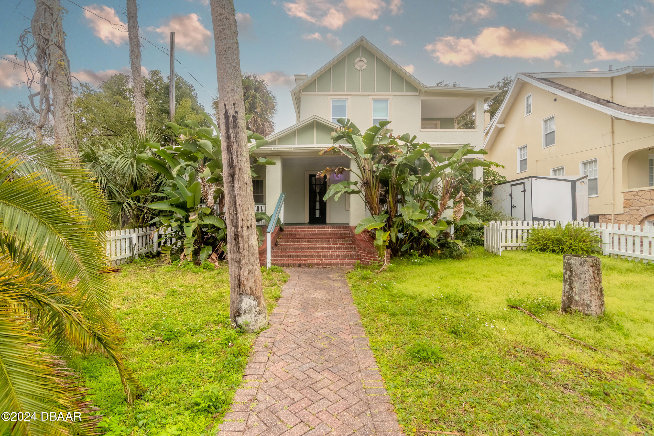 a front view of a house with garden