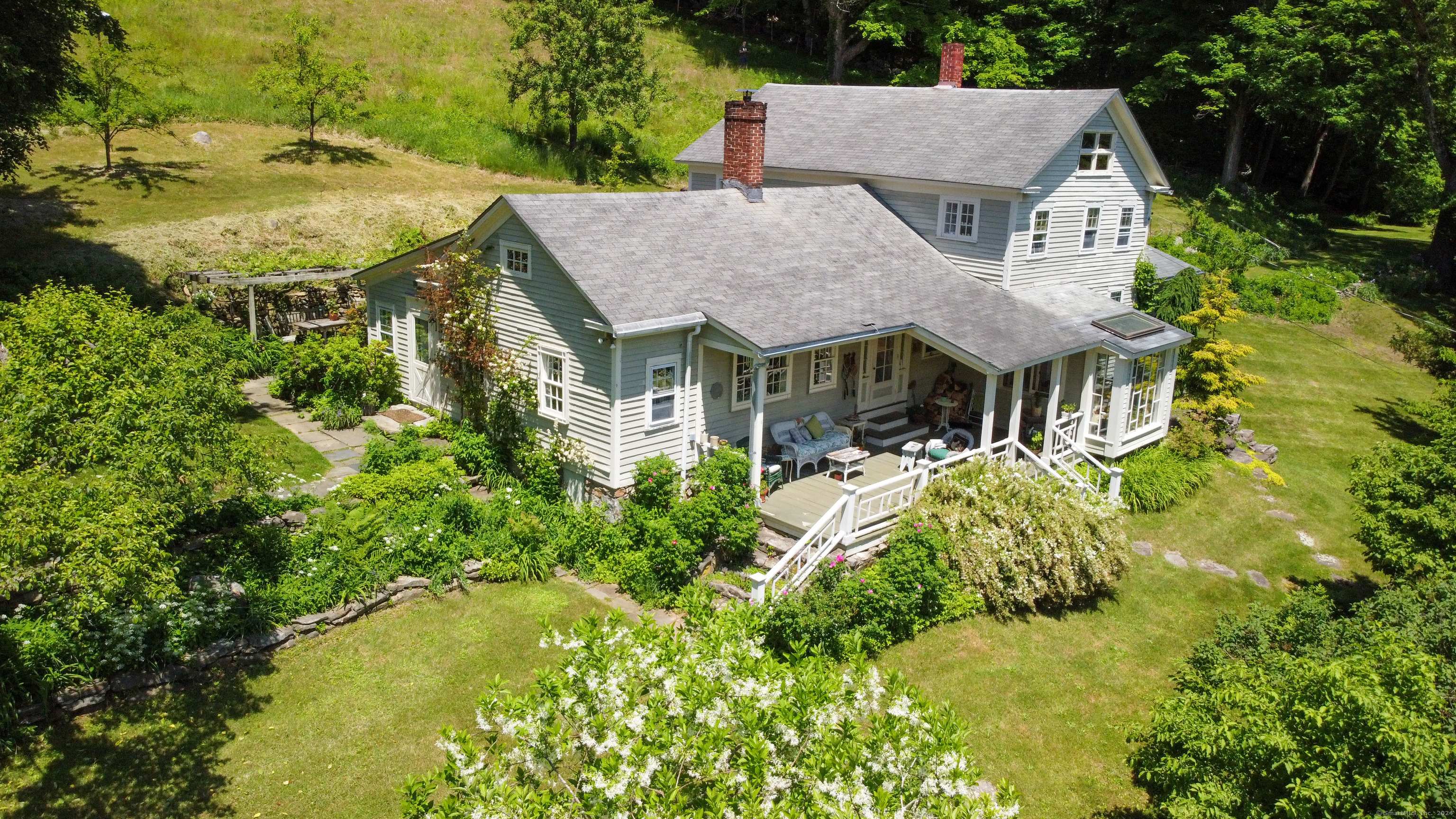 an aerial view of a house with swimming pool and garden