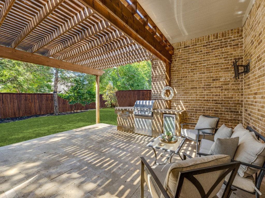 a view of a patio with a table chairs and a backyard