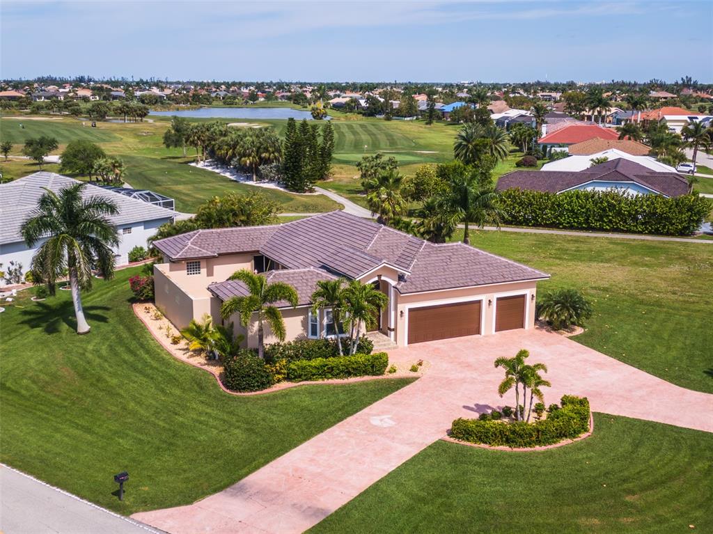 a view of a house with a yard and a swimming pool