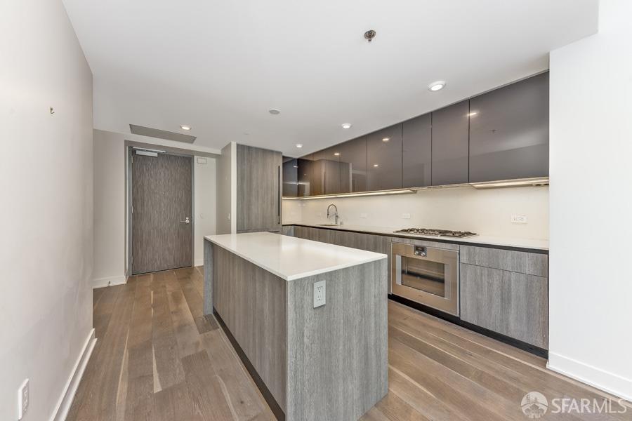 a kitchen with granite countertop a sink and a stove top oven