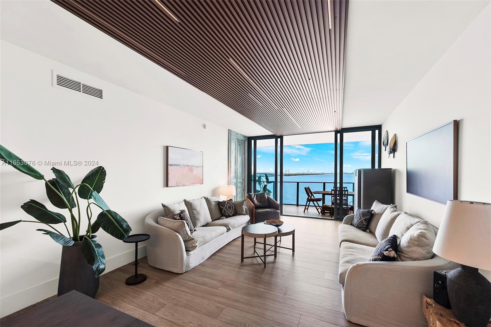 a living room with furniture floor to ceiling window and floor to ceiling window