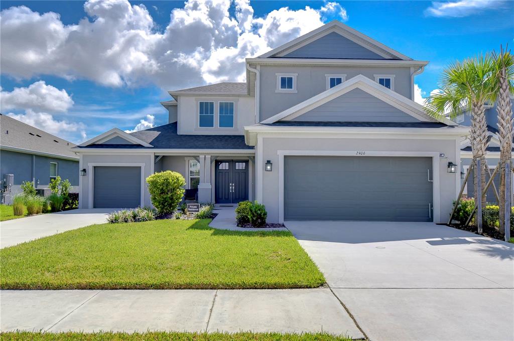 a front view of a house with a yard and garage