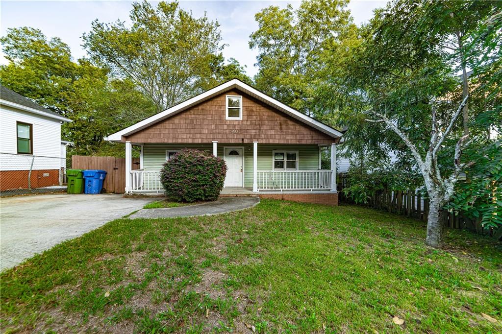 a front view of a house with a garden