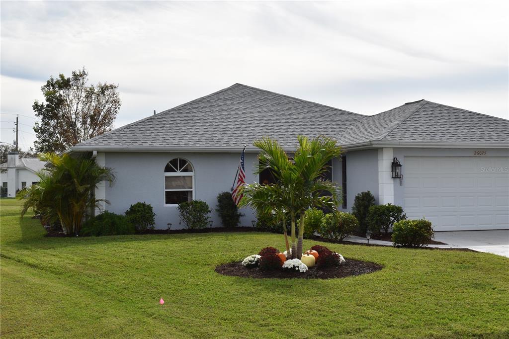 a front view of house with a garden