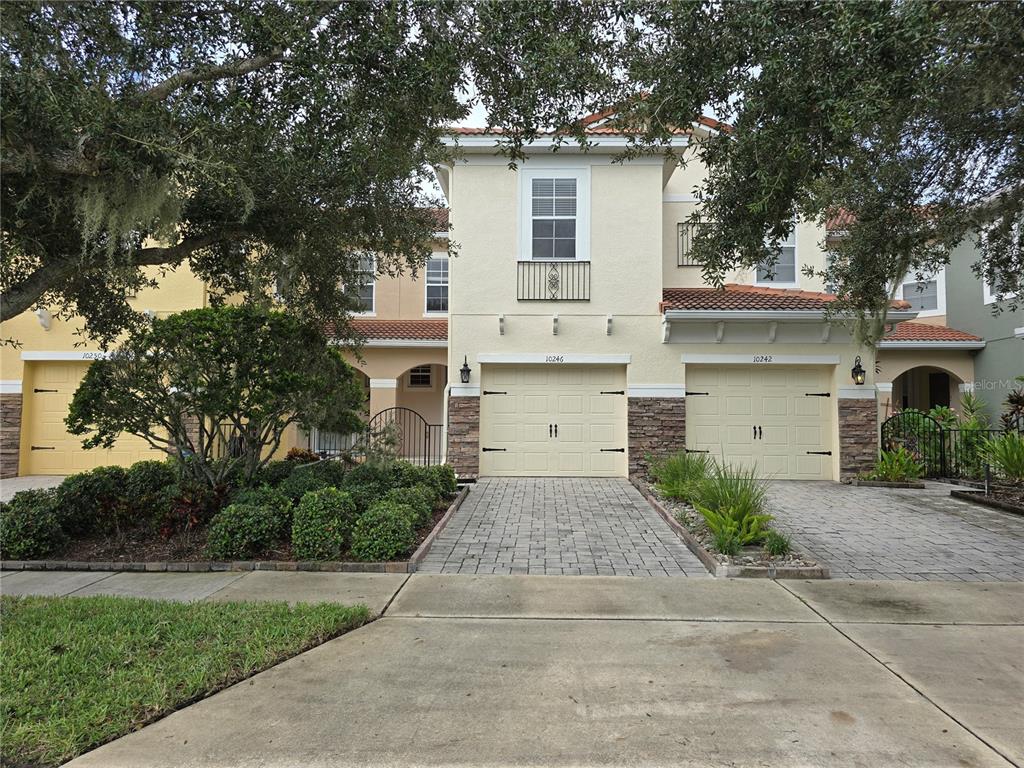 a front view of a house with a yard and a garage