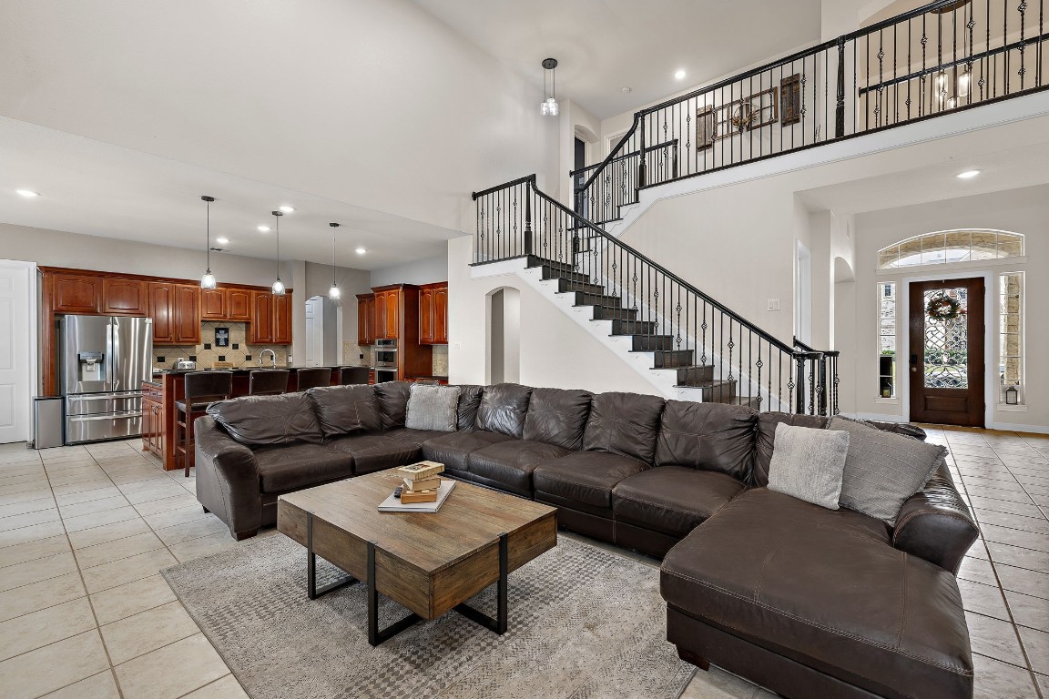 a living room with furniture and a ceiling fan