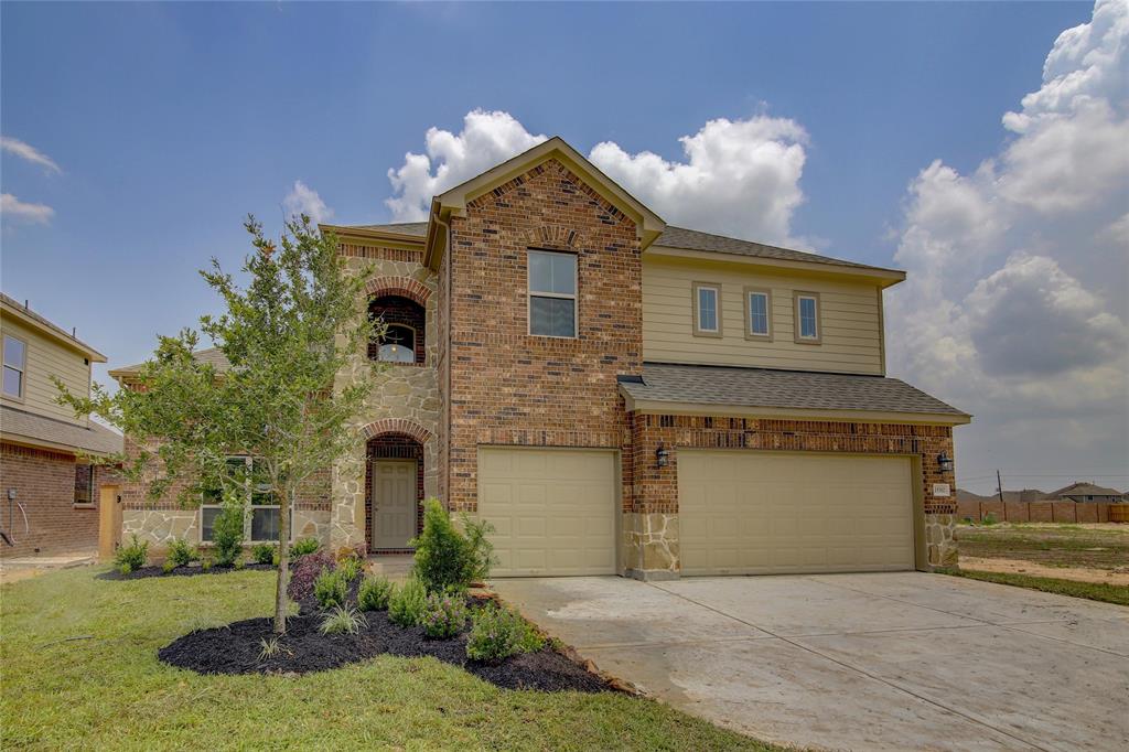 a front view of a house with a yard and garage