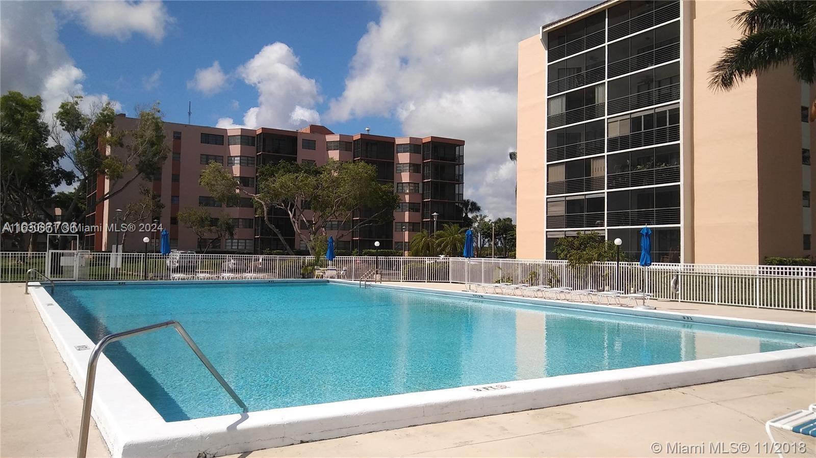 a view of swimming pool with outdoor seating and city view