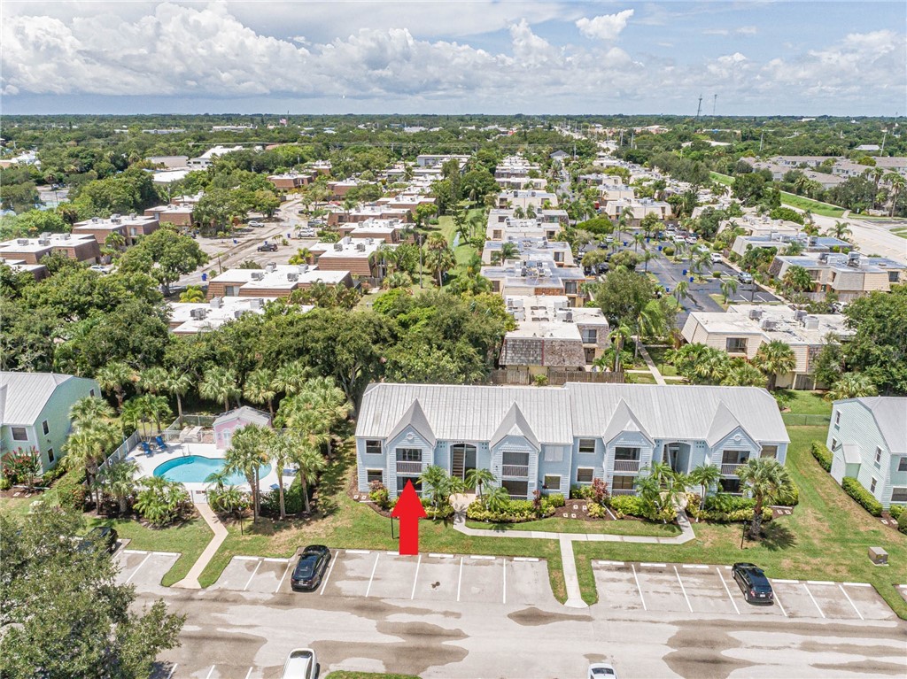 an aerial view of residential houses with outdoor space and swimming pool