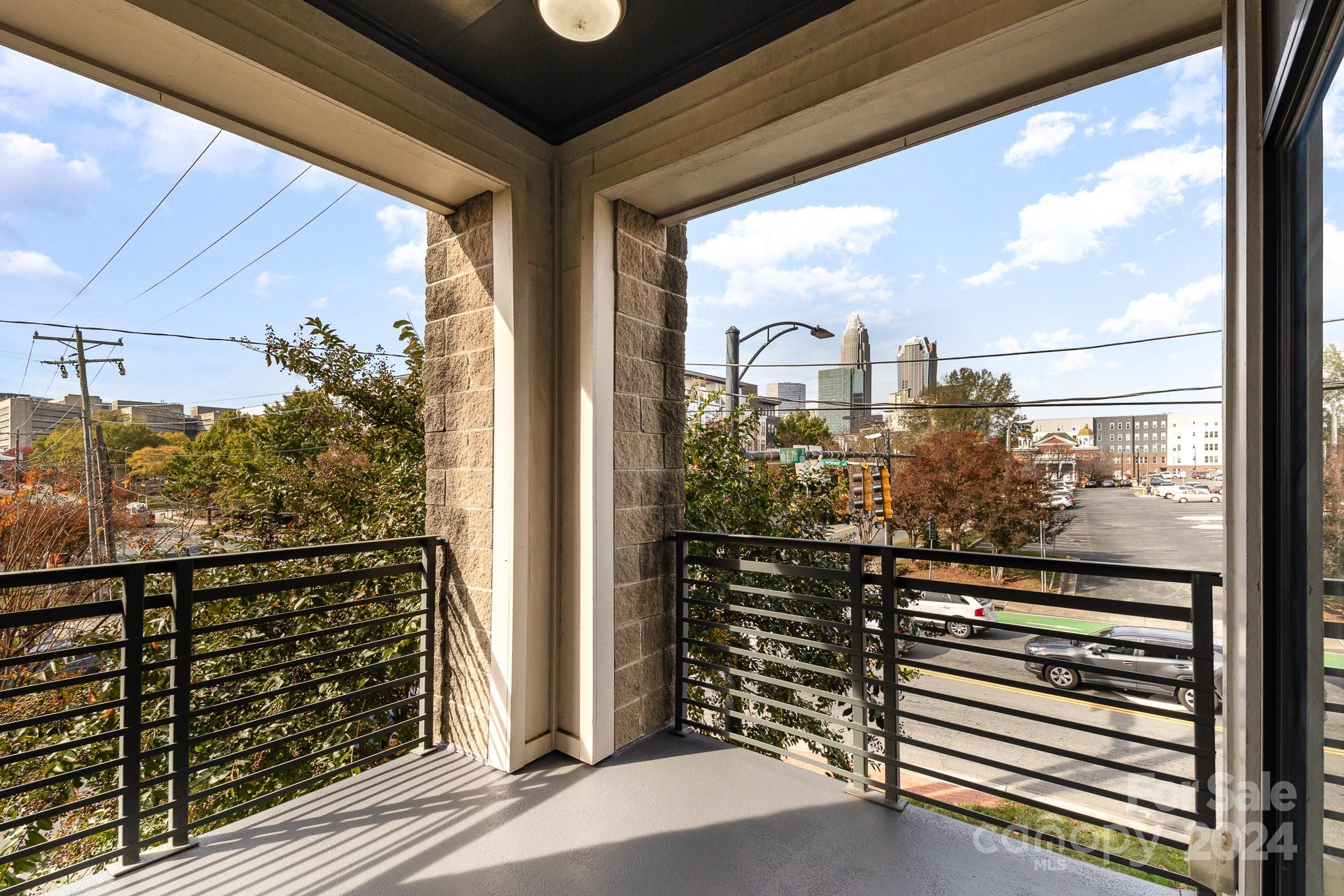 a view of a balcony with wooden floor