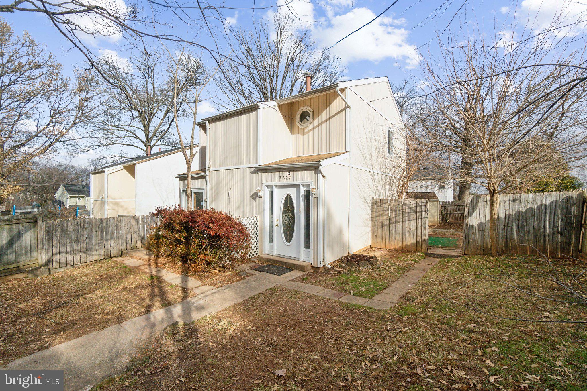 a view of a house with a yard covered in snow