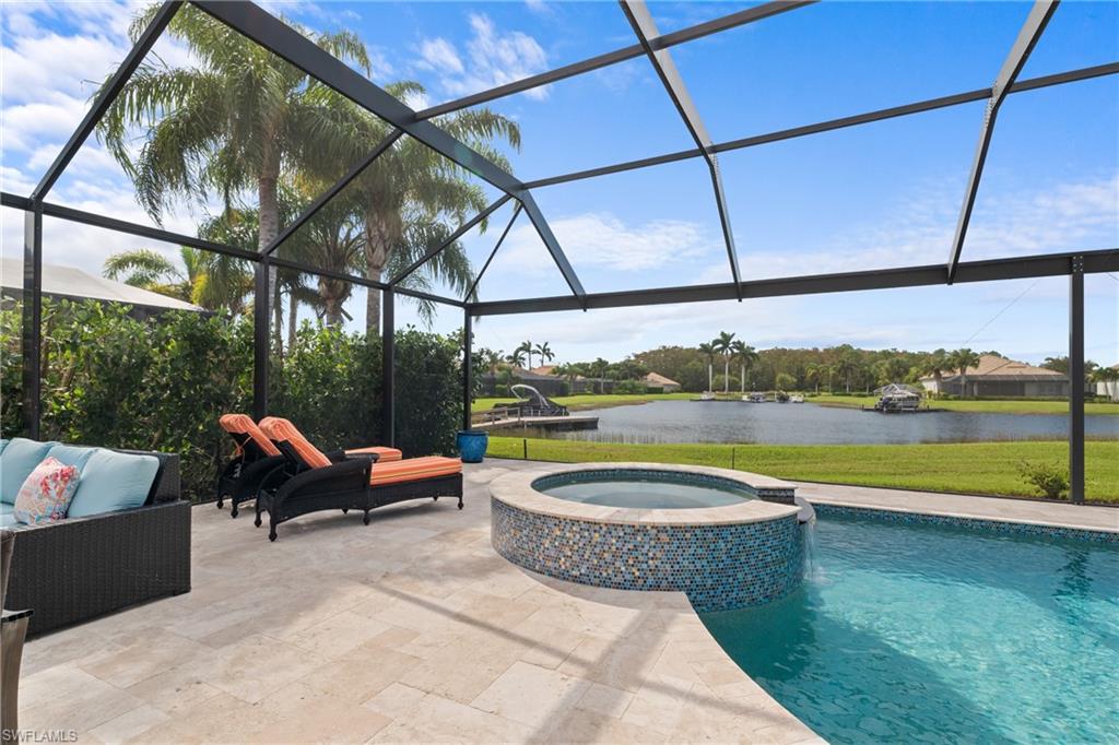 a view of swimming pool with a couches in patio