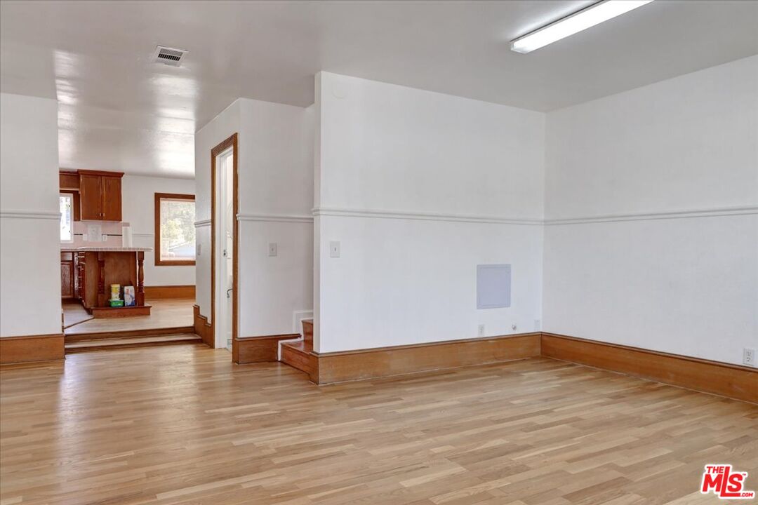 a view of a room with wooden floor