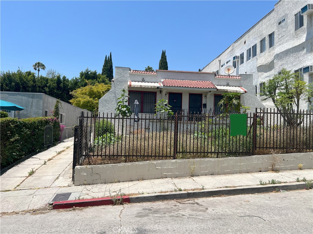 a front view of a house with a garden and plants